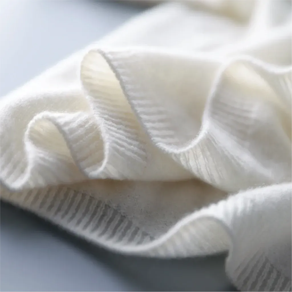 Close-up of a white textured fabric on a light gray background