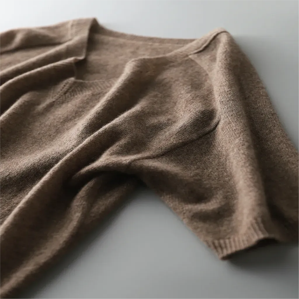 Brown knitted sweater on a light gray background
