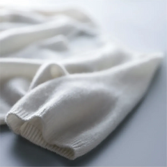 Close-up of white fabric on a light gray background
