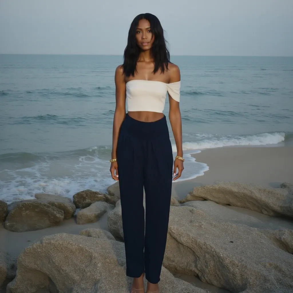 Woman standing on a beach with ocean waves in the background