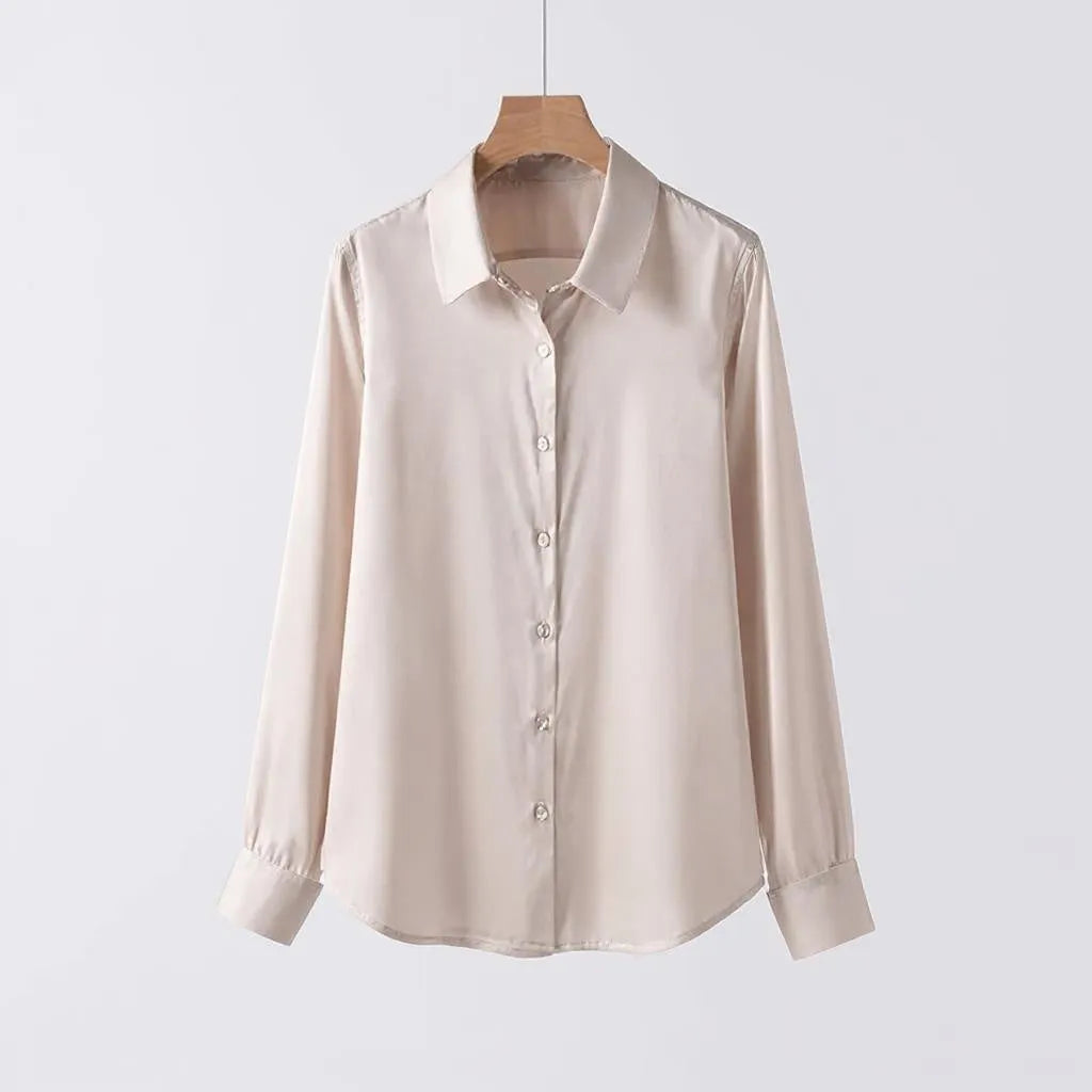 Beige shirt on a wooden hanger against a light gray background