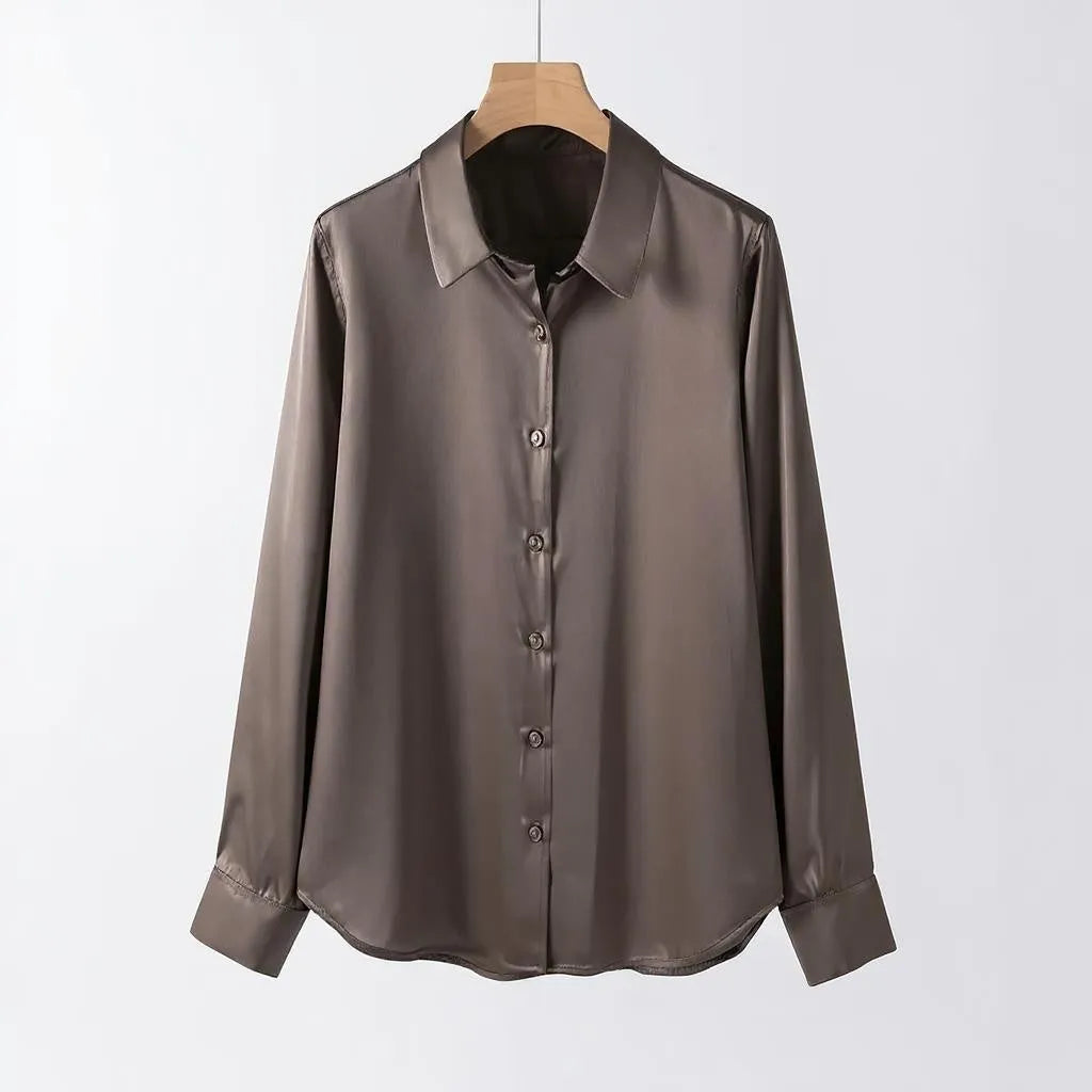 Brown satin shirt on a hanger against a white background
