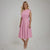 Woman wearing a pink dress on a white background