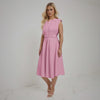 Woman wearing a pink dress on a white background