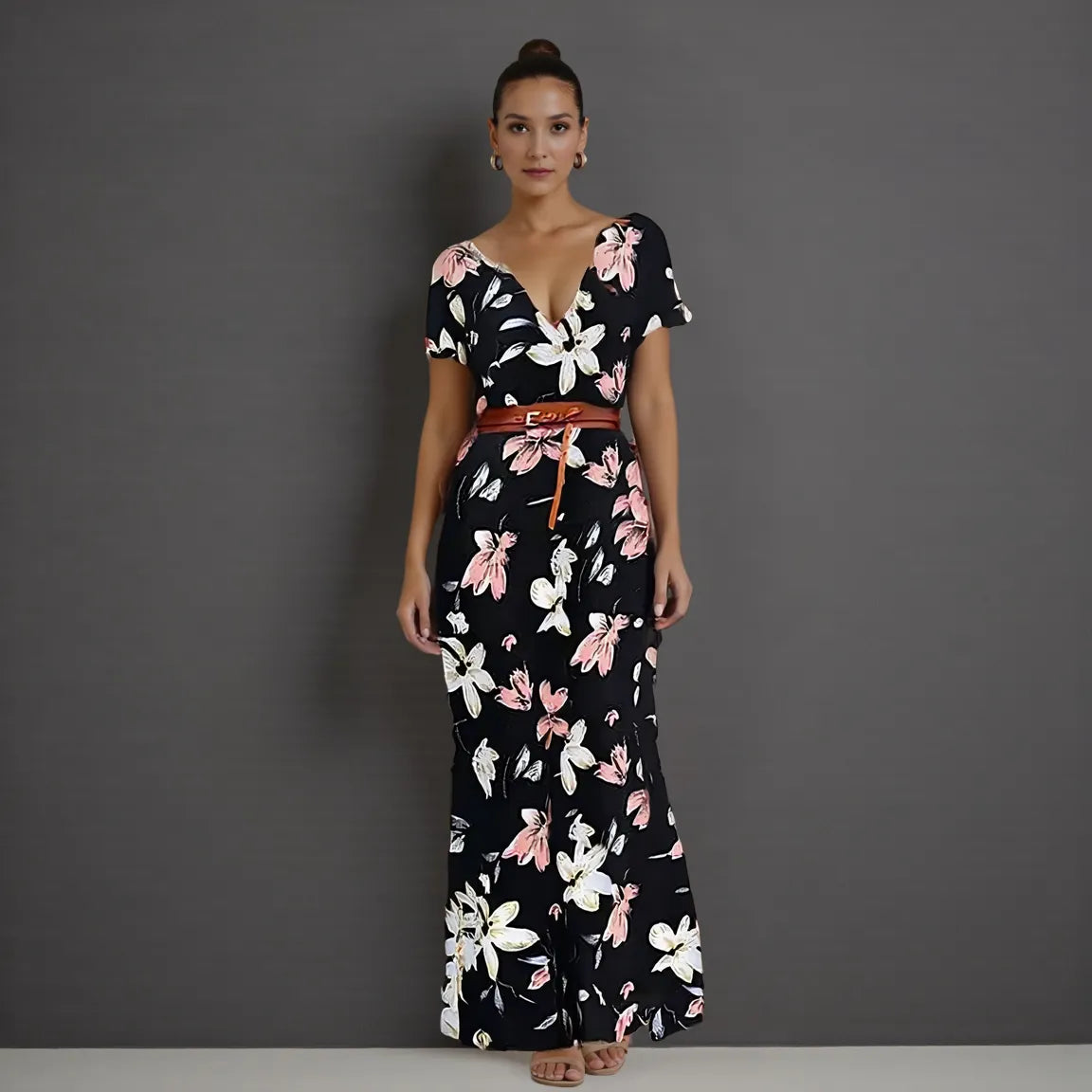 Woman wearing a black floral dress against a gray background