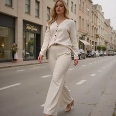 Woman in a white outfit walking on a city street