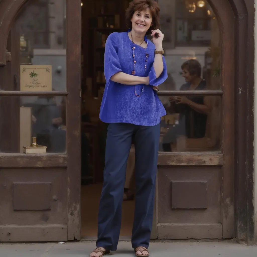 Woman in a blue outfit standing in front of a wooden door.